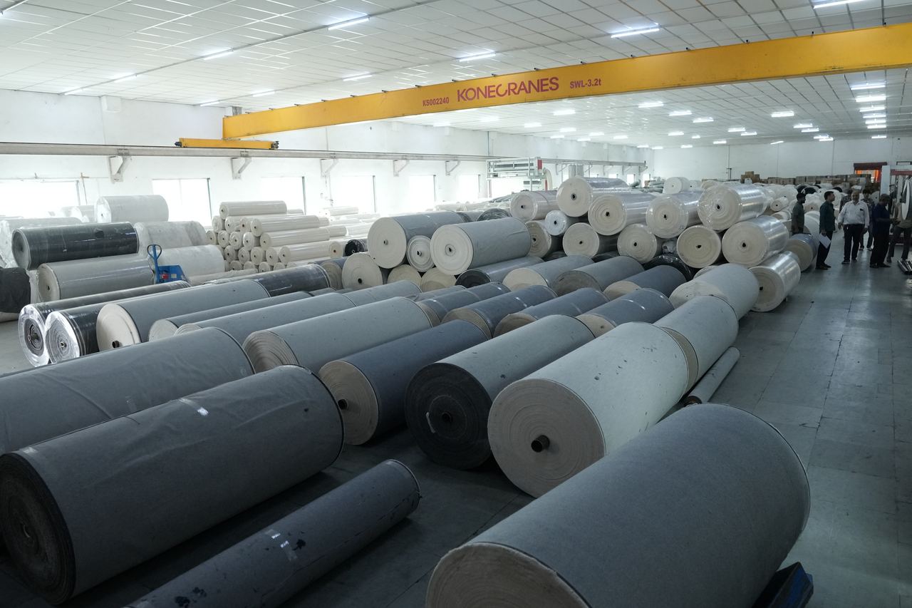 Fabric rolls handled by overhead crane